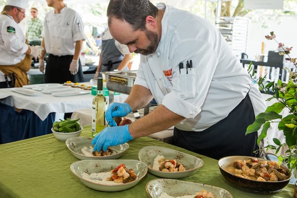 Chef Andrew Smith of West Egg prepares shrimp and grits at the Jekyll Island Shrimp and Grits Festival in 2016.