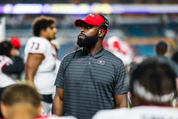 Georgia secondary coach Jahmile Addae prepares to deliver a message to his defensive backs before the College Football Playoff semifinal game at the Capital Orange Bowl against Michigan at Hard Rock Stadium in Miami Gardens, Florida, on Dec. 31. (Photo by Tony Walsh/UGA Athletics)