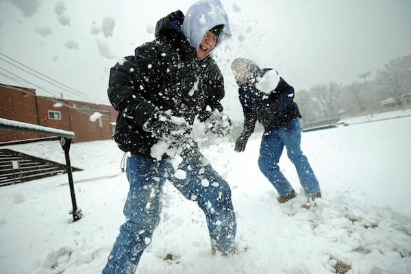 Chuck Cusumano and his son Camden Cusumano snowball each other at Landmark Christian School in Fairburn on February 12, 2010. (Hyosub Shin/ hshin@ajc.com)