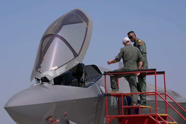 FILE - A U.S. Air Force officer, left, briefs an Indian naval officer about the F-35 fighter aircraft at the static display area on the last day of the Aero India 2025, a biennial event, at Yelahanka air base in Bengaluru, India, Friday, Feb. 14, 2025. (AP Photo/Aijaz Rahi, File)