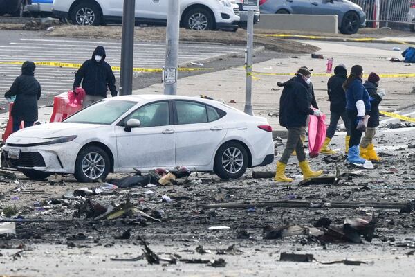 Investigators work the scene after a small plane crashed in Philadelphia, Saturday, Feb. 1, 2025. (AP Photo/Matt Rourke)