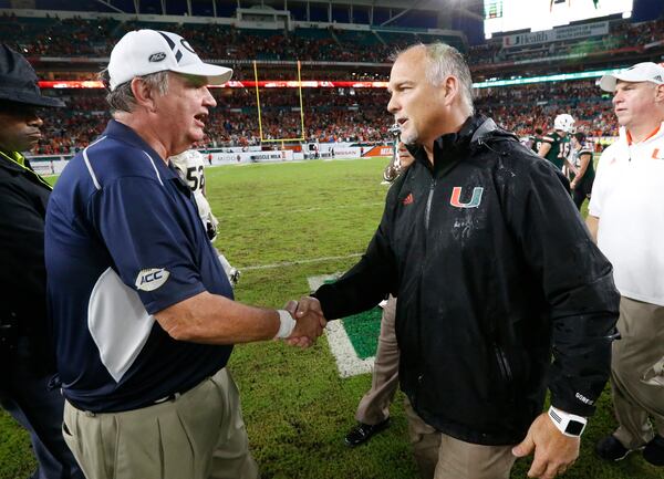 Miami head coach Mark Richt, right, and Georgia Tech head coach Paul Johnson congratulate each other after an NCAA College football game, Saturday, Oct. 14, 2017 in Miami Gardens, Fla. Miami defeated Georgia Tech 25-24. (AP Photo/Wilfredo Lee)