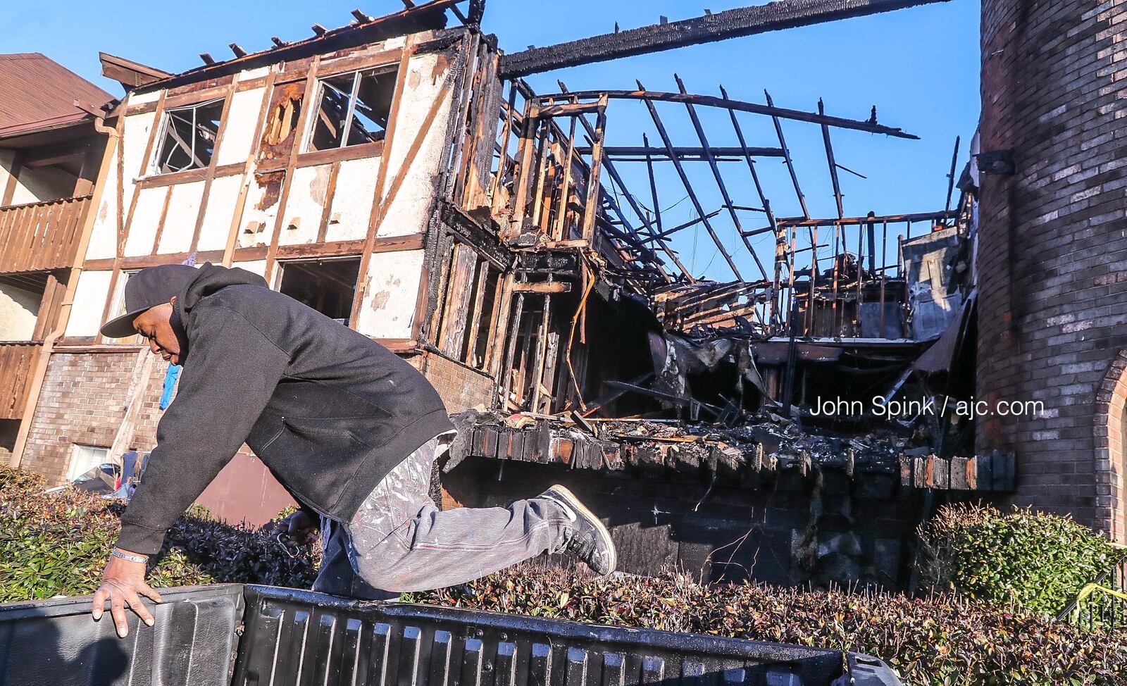 Allen Byron gets ready to push his truck away from the burned structure at Camelot.