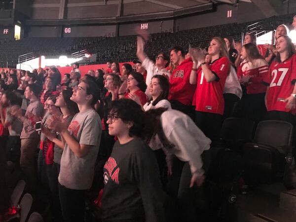 University of Georgia students celebrate a touchdown near the end of the first half at a campus watch party on the campus' Stegeman Coliseum. ERIC STIRGUS / ESTIRGUS@AJC.COM