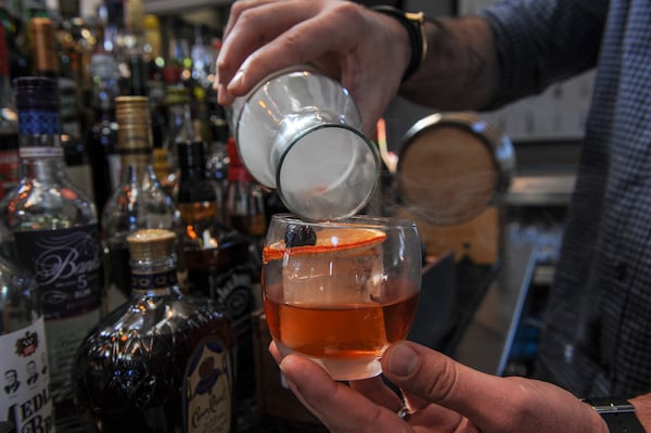 The Smoked Old Fashioned with Diplomatico Anejo Rum, demerara, orange, bitters and hickory smoke is made tableside. CONTRIBUTED BY BECKYSTEIN.COM