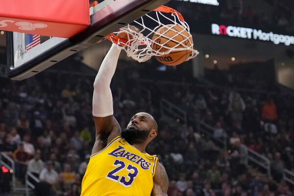 Los Angeles Lakers forward LeBron James (23) dunks in the first half of an NBA basketball game against the Cleveland Cavaliers, Wednesday, Oct. 30, 2024, in Cleveland. (AP Photo/Sue Ogrocki)