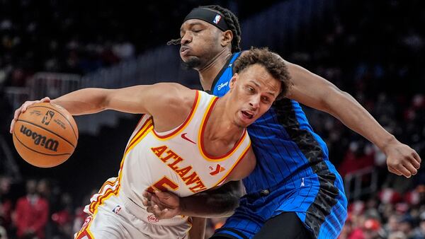 Atlanta Hawks guard Dyson Daniels (5) drives past Orlando Magic center Wendell Carter Jr. (34) during the first half of an NBA basketball game, Thursday, Feb. 20, 2025, in Atlanta. (AP Photo/Mike Stewart)