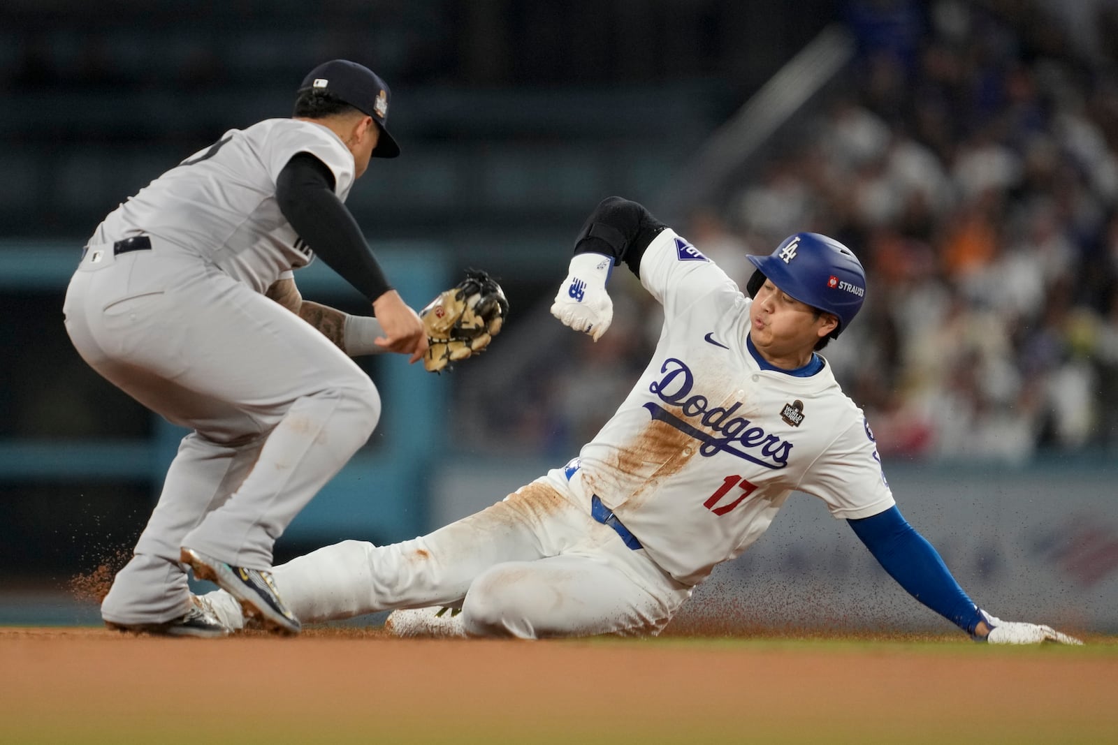 Los Angeles Dodgers' Shohei Ohtani is tagged out by New York Yankees second baseman Gleyber Torres on a steal attempt during the seventh inning in Game 2 of the baseball World Series, Saturday, Oct. 26, 2024, in Los Angeles. Ohtani was injured on the play and helped off the field. (AP Photo/Ashley Landis)