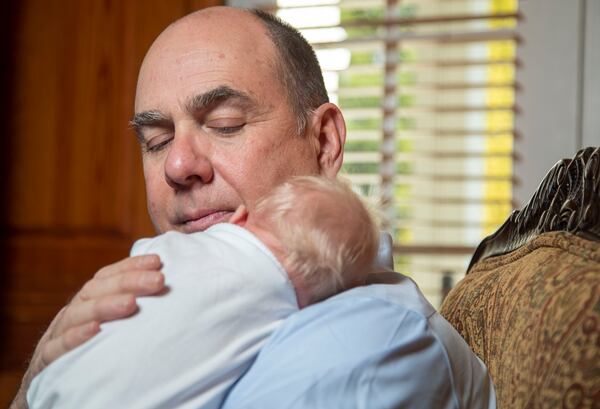 Beatty D’Alessandro cradles his three-week-old grandson Dominic “Beatty” at their residence in Duluth. (Alyssa Pointer / Alyssa.Pointer@ajc.com)