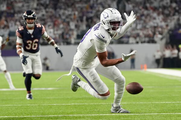 Minnesota Vikings wide receiver Justin Jefferson (18) reaches for an incomplete pass during the first half of an NFL football game against the Chicago Bears, Monday, Dec. 16, 2024, in Minneapolis. (AP Photo/Abbie Parr)