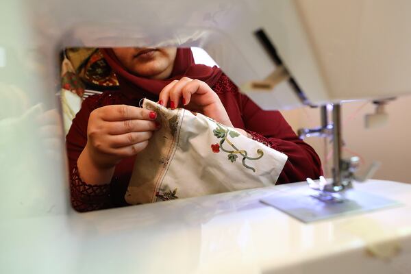 An Afghan refugee learns how to sew in the training room at Peace of Thread on Thursday, Aug. 4, 2022, in Clarkston. Curtis Compton / Curtis Compton@ajc.com