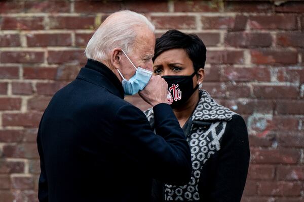 President-elect Joe Biden talks backstage with Atlanta Mayor Keisha Lance Bottoms after speaking at a campaign drive-in event in Atlanta on Tuesday, Dec. 15, 2020. Biden urged Georgia voters to cast ballots for two Democratic Senate candidates in a pair of critical runoffs early next month, seeking victories that would give his party full control of the Congress and help Democrats advance the agenda he promised on the campaign trail. (Erin Schaff/The New York Times)