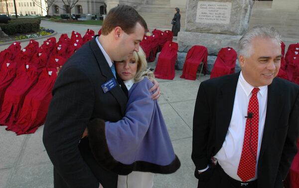 - Sen. Preston Smith (cq)(R-Rome), left, hugs LuGina Brown (cq) as her husband Alan Brown (cq) waits to talk with the media following a press confrence where Smith announced a proposed new law he is sponsoring to place driving simulators in all of Georiga's high schools in the mid-2000s. The law is known as "Joshua's Law" in honor of the Brown's son who died in a car crash in 2003. (BEN GRAY/AJC staff)