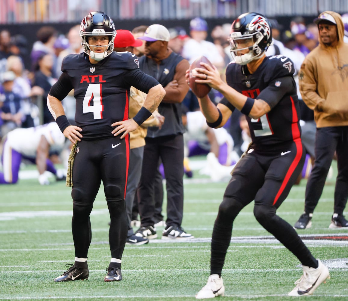 Atlanta Falcons starting quarterback Taylor Heinicke (4) watches quarterback Desmond Ridder (9) during warmups before an NFL football game In Atlanta on Sunday, Nov. 5, 2023 between the Atlanta Falcons and the Minnesota Vikings. (Bob Andres for the Atlanta Journal Constitution)