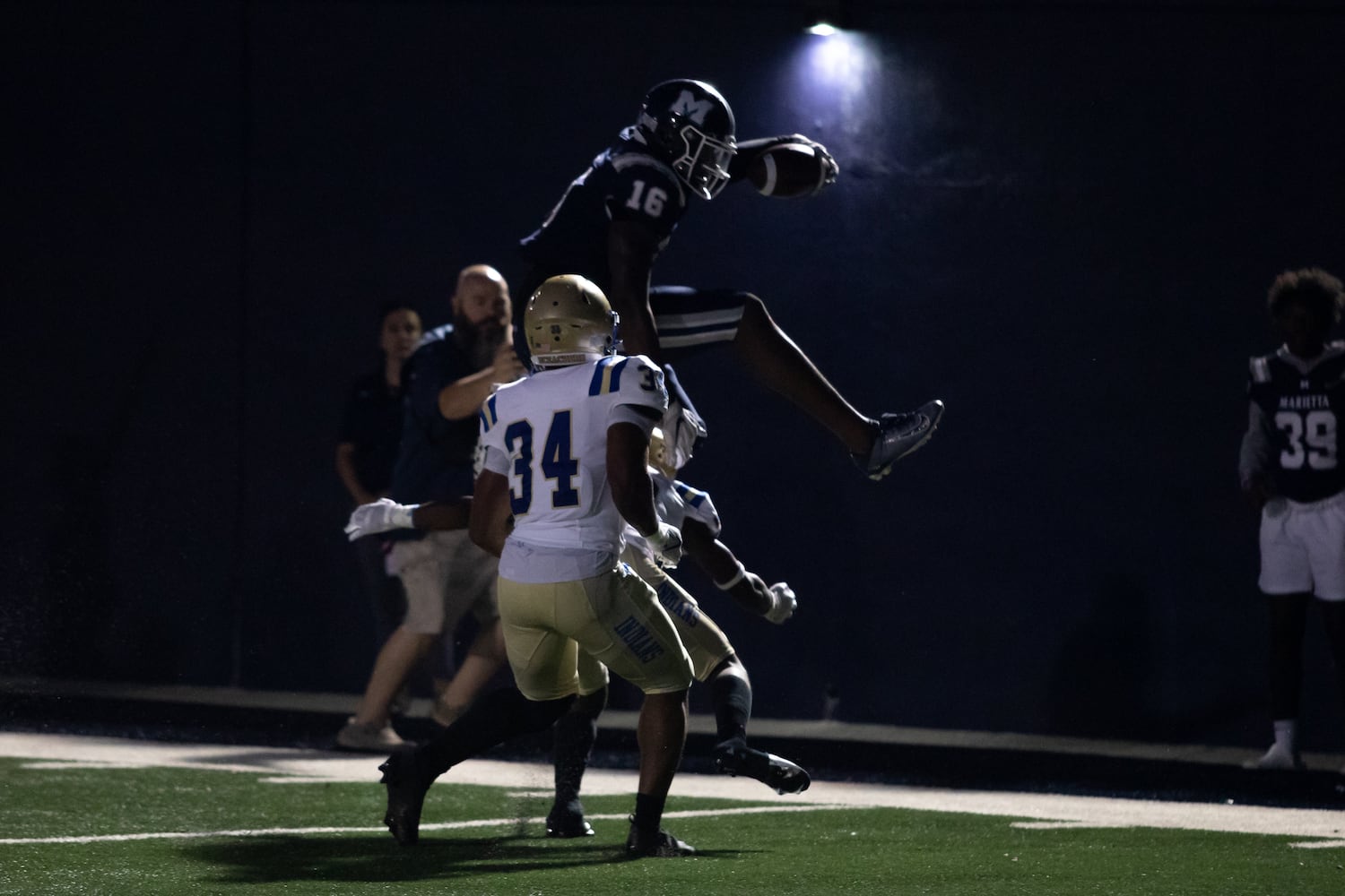 Marietta's J'kelyn Carroll (16) jumps towards the end zone at a high school football game between McEachern High School and Marietta High School at Northcutt Stadium in Marietta, Ga., on Friday, Sept. 3, 2021.  (Photo/ Jenn Finch, The Atlanta Journal-Constitution)