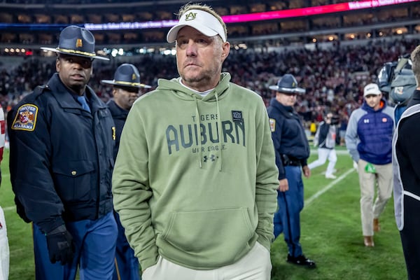 Auburn head coach Hugh Freeze, center, walks off the field after an NCAA college football game against Alabama, Saturday, Nov. 30, 2024, in Tuscaloosa, Ala. (AP Photo/Vasha Hunt)