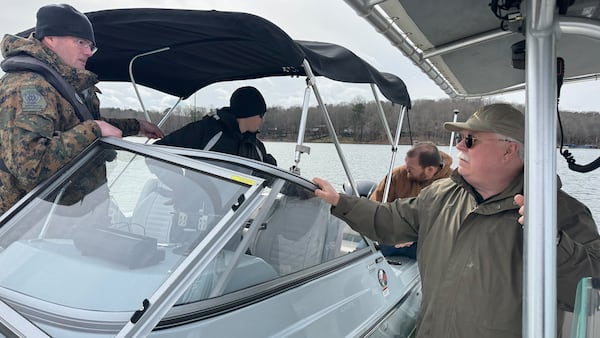 Putnam County Sheriff Howard Sills speaks with officers with the Georgia Department of Natural Resources on Thursday as they search Lake Oconee for Gary Jones, a track and field coach at the Westminster Schools missing since Saturday. ( Joe Kovac Jr. / joe.kovac@ajc.com)