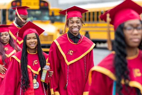 Darren Williams (center), a member of Creekside High School’s Tribe Academy, walks with Creekside students before their graduation ceremony at Gateway Arena in College Park on Thursday, May 18, 2023. (Arvin Temkar / arvin.temkar@ajc.com)