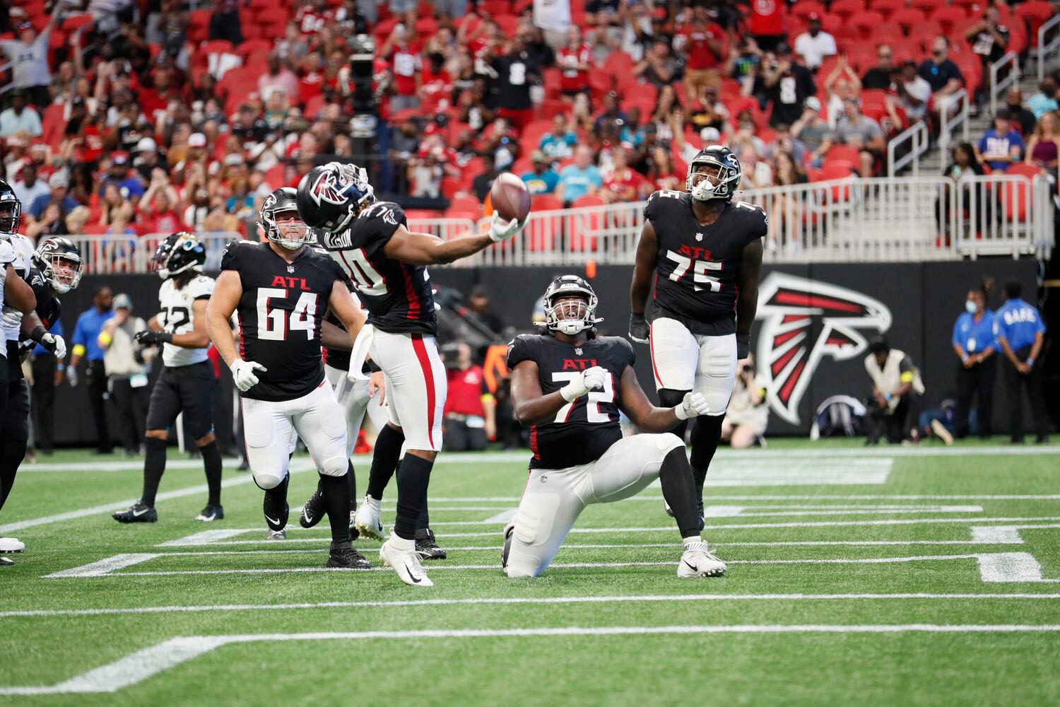 Atlanta Falcons' running back Qadree Ollison (30) tosses the ball as he celebrates the second touchdown of the Falcons during the second half of an NFL exhibition game against the Jacksonville, Jaguars on Saturday, August 27, 2022, at the Mercedes-Benz Stadium in Atlanta, Ga.
 Miguel Martinez / miguel.martinezjimenez@ajc.com