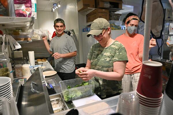 Cristy Kisner (center) is busy working in the kitchen at Cristy's Kitchen in Roswell. (Hyosub Shin / Hyosub.Shin@ajc.com)