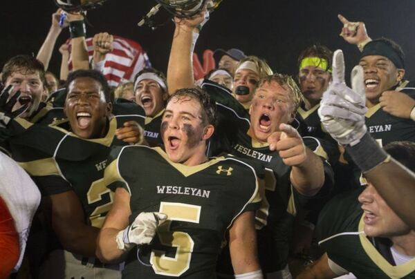 Wesleyan Wolves football players celebrate their 18-9 victory over Pace Academy Knights at home in Peachtree Corners on Friday September 25, 2015. (Phil Skinner/Special) to the AJC