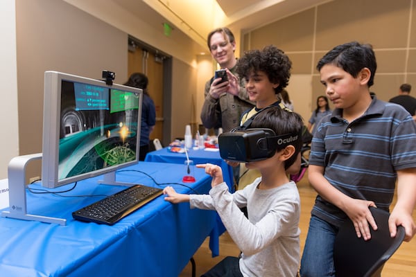 Children explore a virtual reality simulation at the Atlanta Science Festival. (Courtesy of Rob Felt 2016)