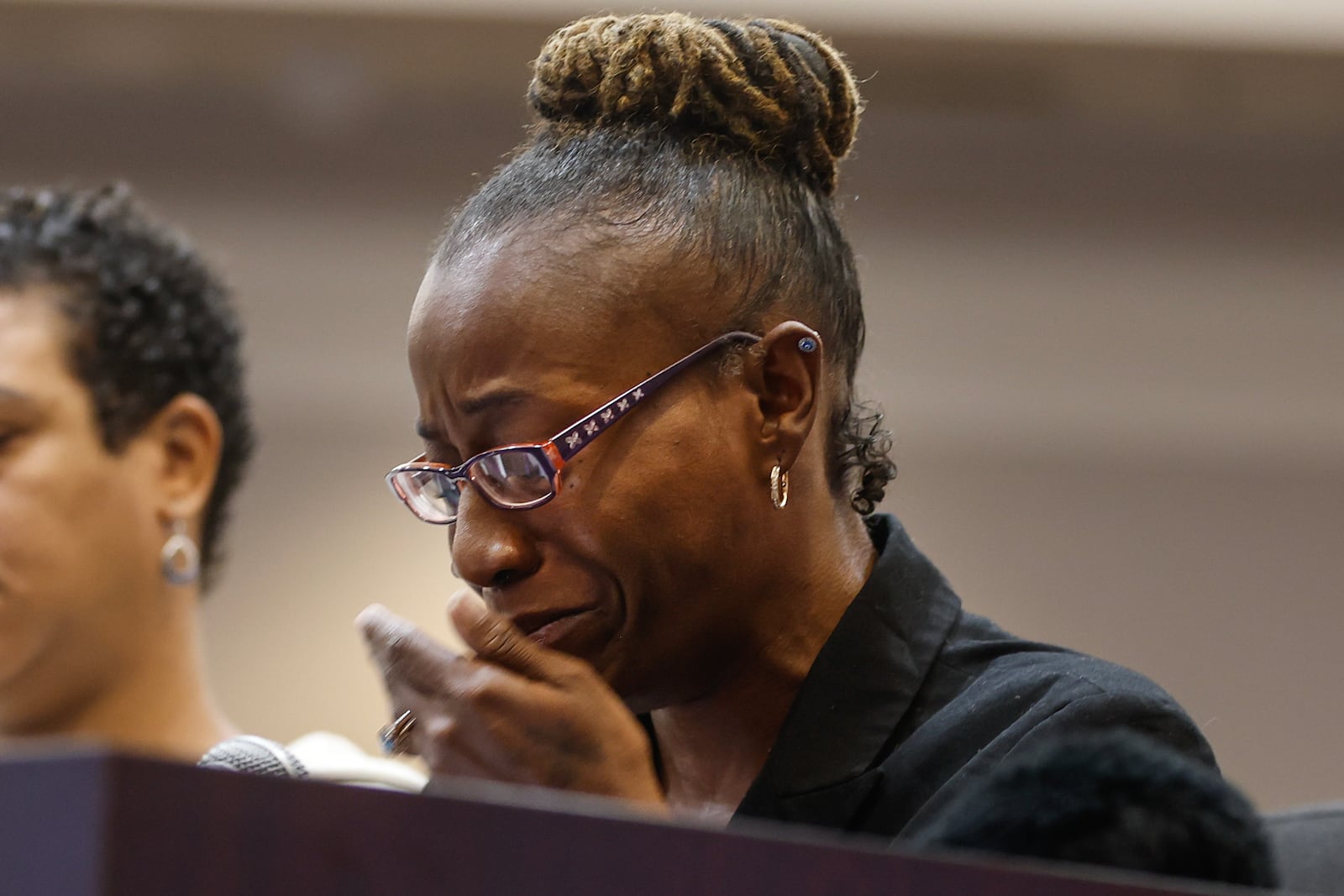 Miracle Fletcher, a tenant of Chelsea Tree Villages Apartments cries as she testifies during a U.S. Senate Human Rights Subcommittee Hearing addressing unsuitable housing conditions at Roswell City Hall on Monday, March 4, 2024. (Natrice Miller/ Natrice.miller@ajc.com)