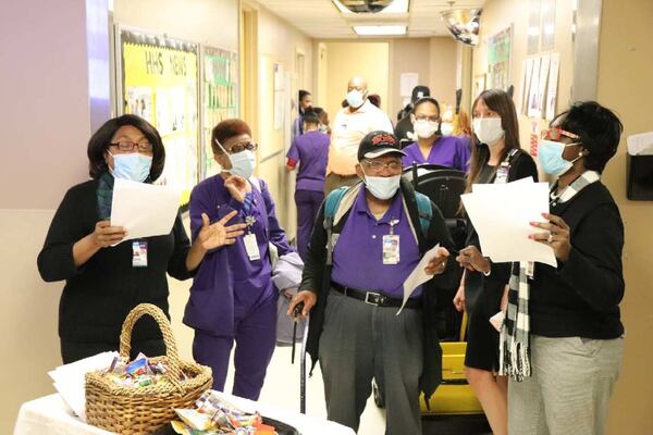 Wellstar chaplains lead housekeeping employees in a song to help keep their spirits up. From left to right, Chaplain Jean Beedoe; employee Pat Character; employee Jerry Hall, who is retiring in December; Kat Roberts, Manager of Integrative Health; and Patricia Symonette, Director of Spiritual Health. CONTRIBUTED