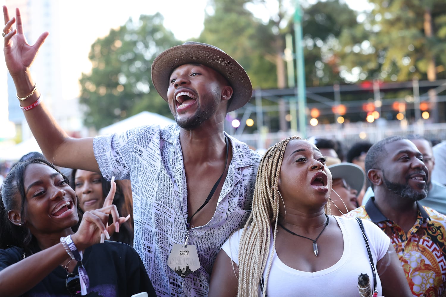 Michael Curtis from Memphis, Tennessee,  and Elon Smith (left) and Porchse Miller, both from Atlanta, sing together as DJ Kash entertained the fans before the Isley Brothers hit the stage. Sunday, October 10, 2021. Miguel Martinez for The Atlanta Journal-Constitution