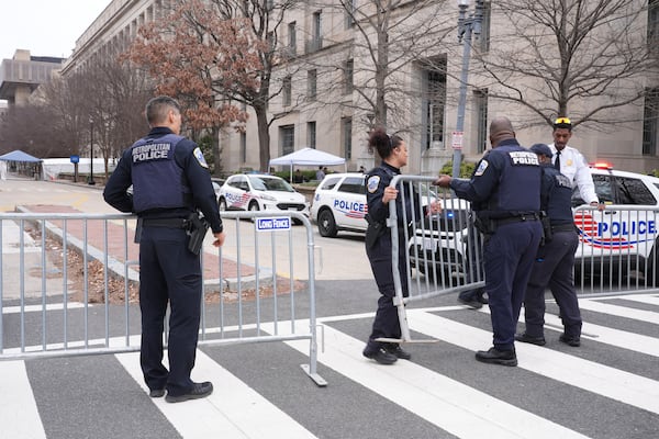 Washington Metropolitan Police officers secure the area around the Justice Department before President Donald Trump speaks Friday, March 14, 2025, in Washington. (AP Photo/Jacquelyn Martin)