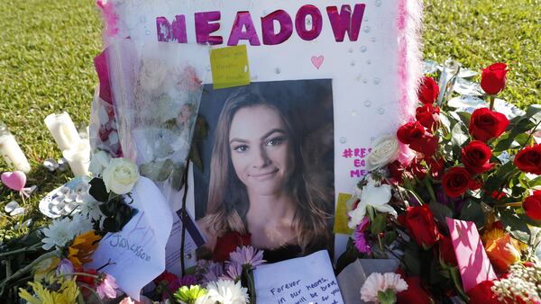 A photo of Meadow Pollack, one of the 17 victims killed in the Feb. 14, 2018, shooting at Marjory Stoneman Douglas High School sits against a cross as part of a public memorial in Parkland, Florida. Nikolas Cruz, a former student, was charged with 17 counts of premeditated murder in the massacre.