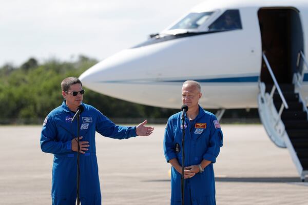 NASA astronauts Bob Behnken, left, and Doug Hurley speak during a news conference after they arrived at the Kennedy Space Center. 