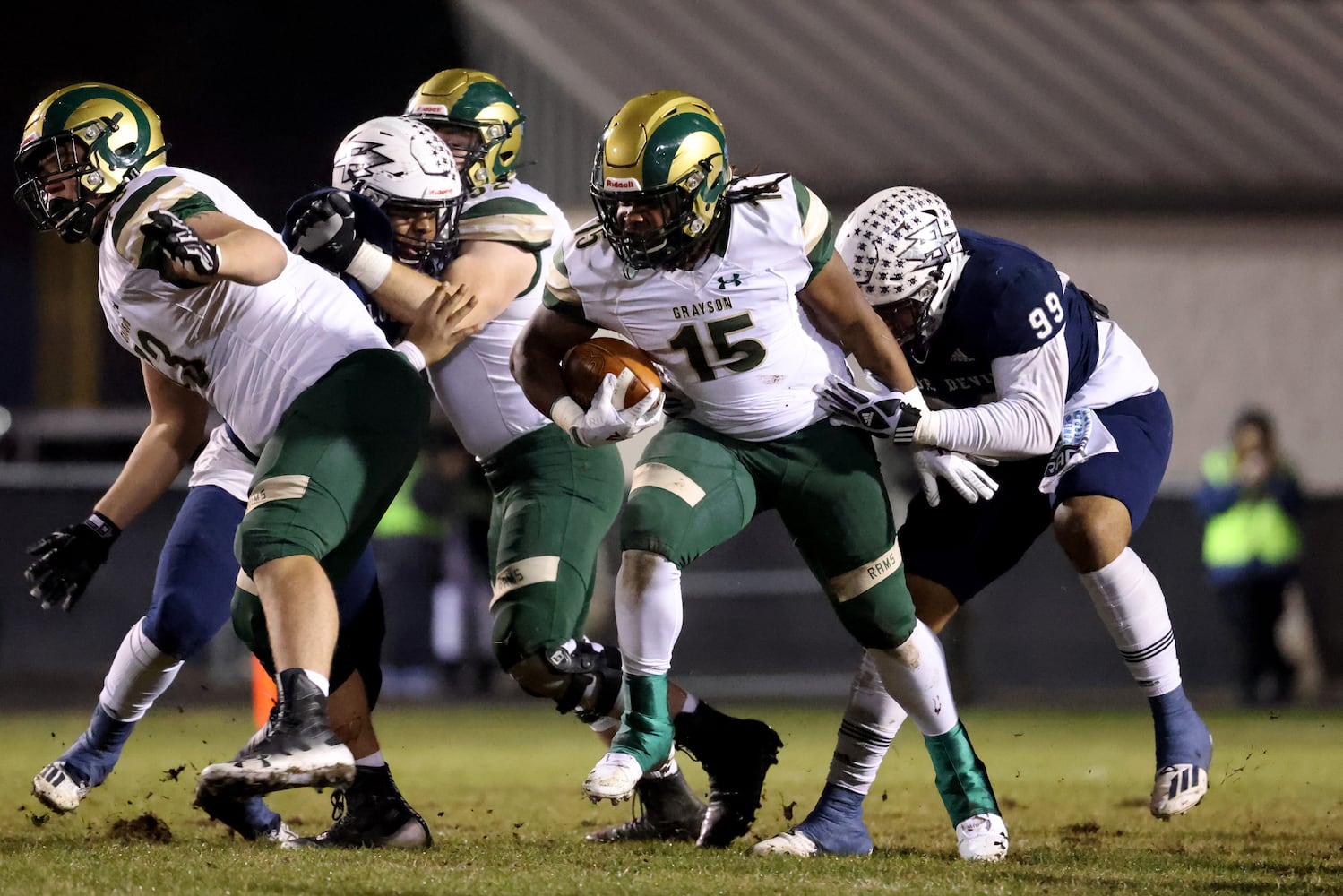 Dec. 18, 2020 - Norcross, Ga: Grayson running back Joseph Taylor (15) runs against Norcross defensive lineman Kamren Lark (99) in the first half of the Class AAAAAAA semi-final game at Norcross high school Friday, December 18, 2020 in Suwanee, Ga.. JASON GETZ FOR THE ATLANTA JOURNAL-CONSTITUTION