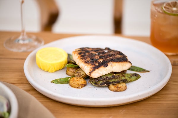 Grilled Snapper with blistered sugar snaps, potato coins, espelette, za'atar, and lemon. Photo credit- Mia Yakel.