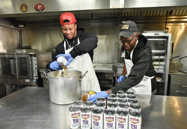 New York Giants running back Saquon Barkley (left) with Clyde Corbin, kitchen director at Crossroads Community Ministries, prepares chicken noodle soup at Crossroads Community Ministries in Atlanta on Friday, February 1, 2019. Campbell’s donated and distributed 100,000 bowls of soup with New York Giants running back Saquon Barkley’s help to Missions for Ministry, a local organization committed to giving back to those in need of food and shelter. This NFL season, Campbell’s plans to donate over 400,000 bowls of soup to hunger relief organizations across the country where they do business. 