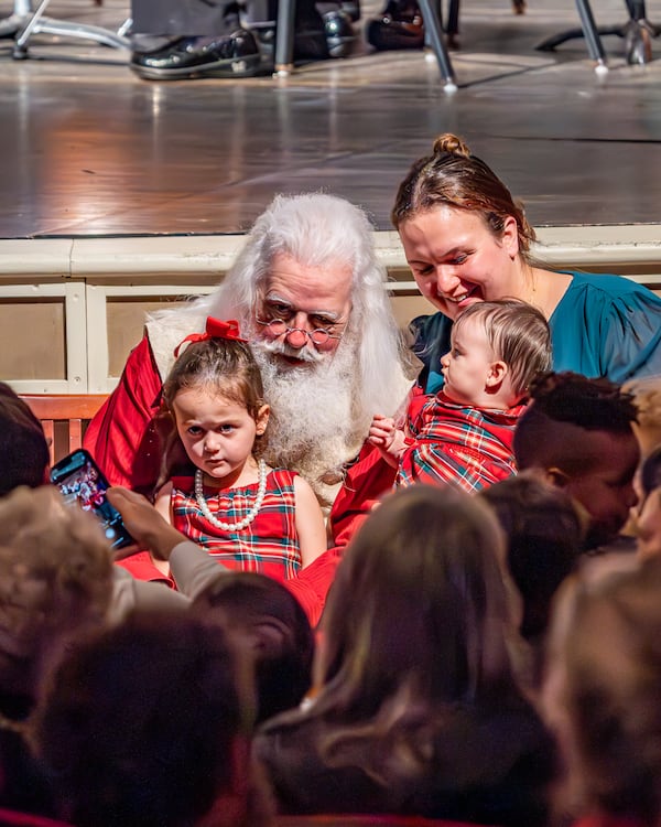 Santa Claus, played by Jonathan Byrd, meets with children during a Christmas performance by the Athens Symphony in December, 2024.