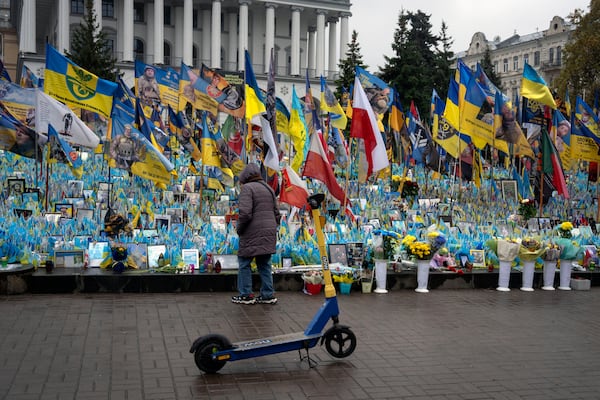 A woman looks at the memorial to fallen soldiers in Independence Square in Kyiv, Ukraine, Friday, Nov. 15, 2024. (AP Photo/Efrem Lukatsky)