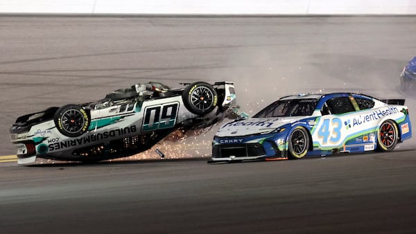 Ryan Preece (60) flips upside down as he crashes going in to turn 3 as Erik Jones (43) goes past during the NASCAR Daytona 500 auto race at Daytona International Speedway, Sunday, Feb. 16, 2025, in Daytona Beach, Fla. (AP Photo/Mike Troxell)