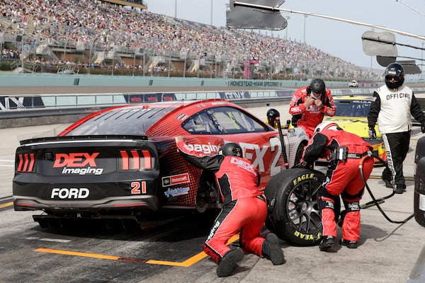 Crew members for Josh Berry work on his car after spinning on pit road during a NASCAR Cup Series auto race at Homestead-Miami Speedway in Homestead, Fla., Sunday, March 23, 2025. (AP Photo/Terry Renna)