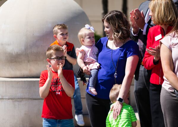 Spencer Muzio holds her daughter Audrey and stands with her other children Cade, Jarrett and Peyton during the Children, Family, and School Choice Bill Signing Ceremony on Thursday, May 6, 2021, in Liberty Plaza at the Georgia State Capitol in Atlanta. Governor Kemp signed House Bill 128, Senate Bill 42, Senate Bill 47, Senate Bill 246, and House Bill 606 into law at the event. CHRISTINA MATACOTTA FOR THE ATLANTA JOURNAL-CONSTITUTION