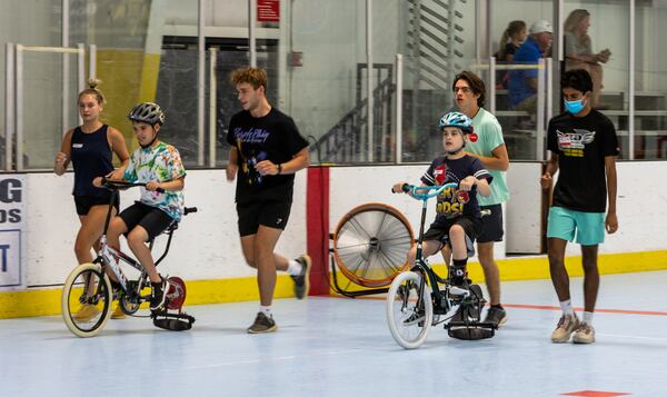 Special needs people learned how to ride a two-wheel bike with adaptations during the iCan Bike Alpharetta camp at The Cooler in Alpharetta.  PHIL SKINNER FOR THE ATLANTA JOURNAL-CONSTITUTION.