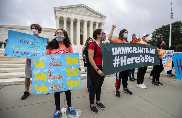 Deferred Action for Childhood Arrivals (DACA) students celebrate in front of the U.S. Supreme Court after the Supreme Court rejects President Donald Trump’s bid to end legal protections for young immigrants, Thursday, June 18, 2020, in Washington. (AP Photo/Manuel Balce Ceneta)