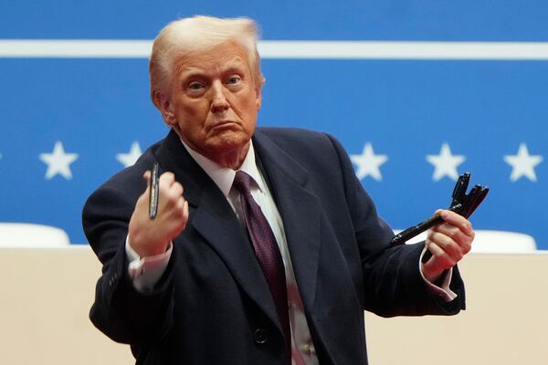 FILE - President Donald Trump throws pens used to sign executive orders to the crowd during an indoor Presidential Inauguration parade event in Washington, Monday, Jan. 20, 2025. (AP Photo/Matt Rourke, File)