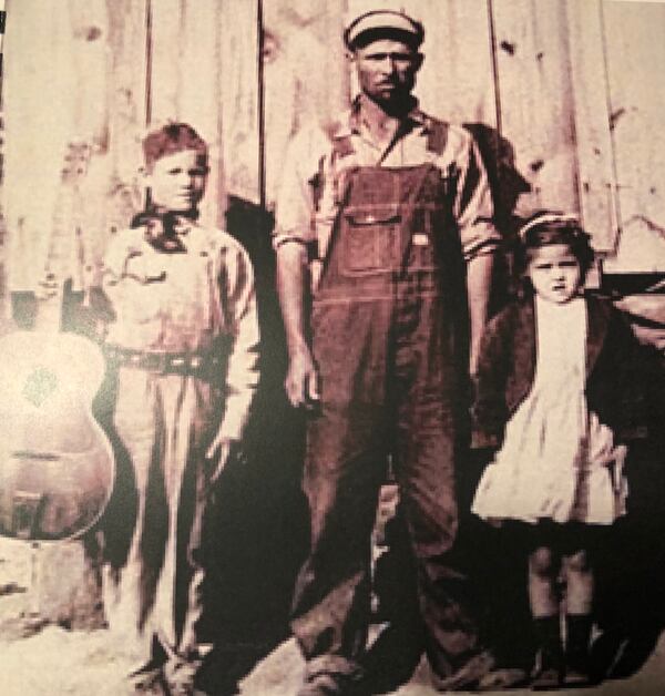 This family photo shows young Terrell Fuller, holding the guitar, with his father, Marshall, and one of his siblings. Used with permission.