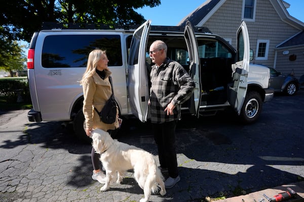 Republican Rylee Linting greets a voter as she campaigns hoping to unseat Democratic State Rep. Jaime Churches, Wednesday, Oct. 16, 2024, in Gibraltar, Mich. (AP Photo/Carlos Osorio)