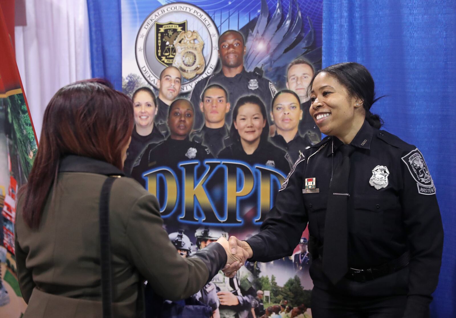 April 13, 2018 - Atlanta, Ga: DeKalb County Police detective Lesa Robinson, right, talks with Sommer Andrews, of Atlanta, during the 15th Annual Jobs Fair at the Georgia International Convention Center Friday, April 13, 2018, in Atlanta. PHOTO / JASON GETZ