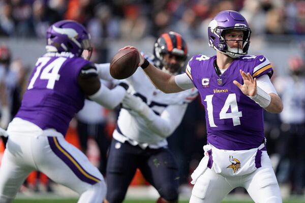 Minnesota Vikings quarterback Sam Darnold (14) throws a pass during the first half of an NFL football game against the Minnesota Vikings, Sunday, Nov. 24, 2024, in Chicago. (AP Photo/Charles Rex Arbogast)