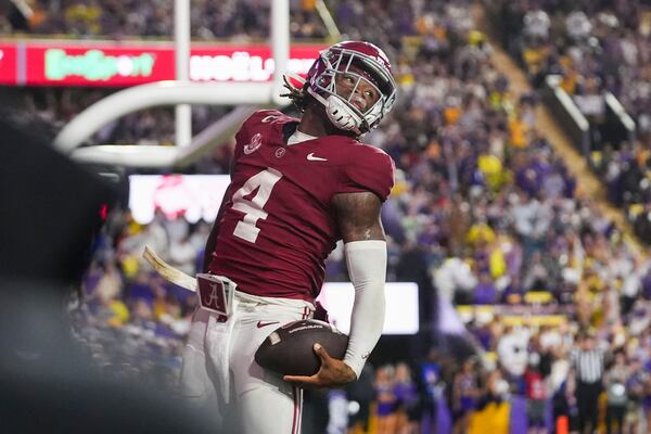 Alabama quarterback Jalen Milroe (4) celebrates a touchdown carry in the second half an NCAA college football game against LSU in Baton Rouge, La., Saturday, Nov. 9, 2024. (AP Photo/Gerald Herbert)