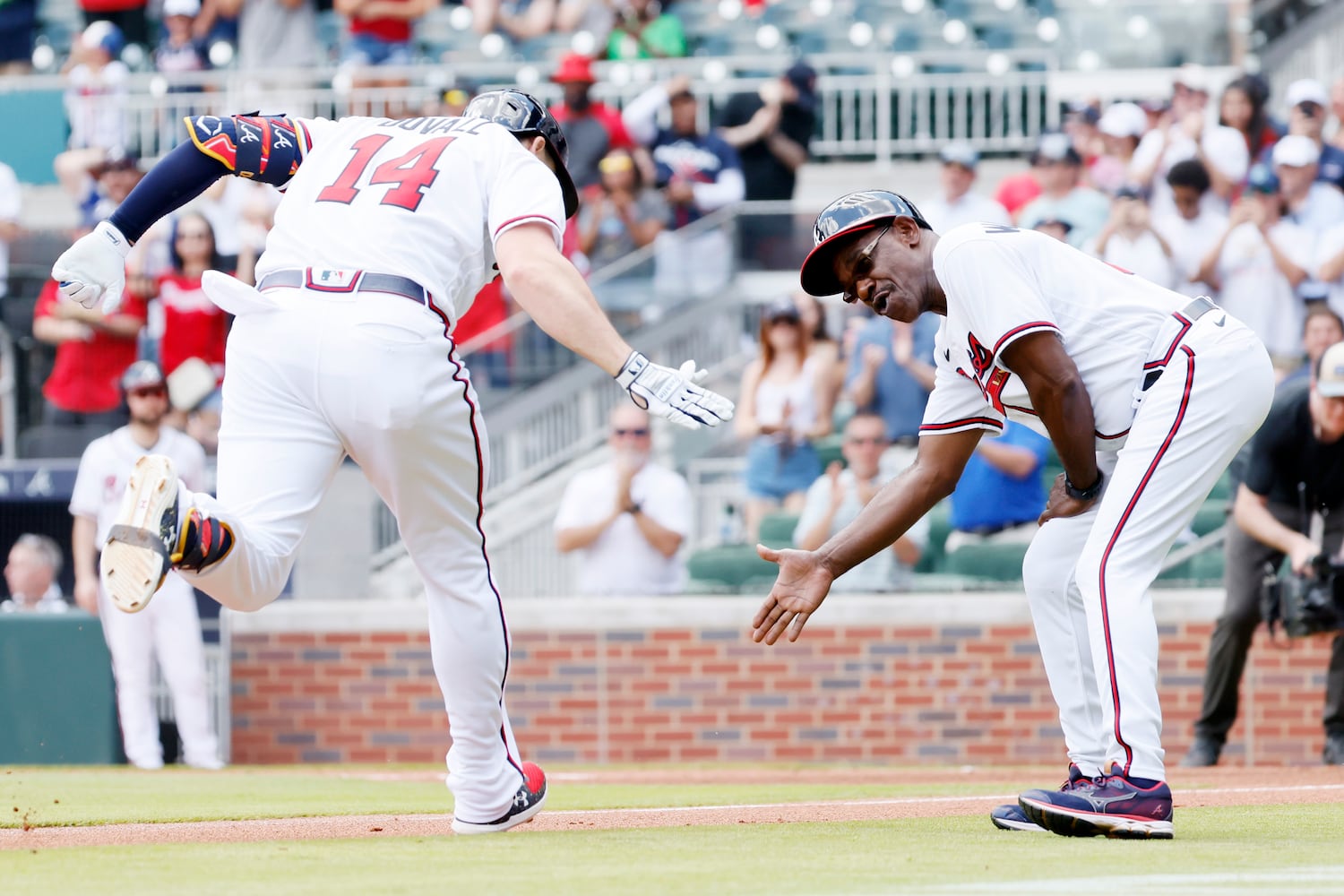 Atlanta Braves left fielder Adam Duvall (14) celebrates with third-base coach Ron Washington after Duvall hit a solo home run during the second inning Sunday, June 12, 2022, in Atlanta. (Miguel Martinez / miguel.martinezjimenez@ajc.com)
