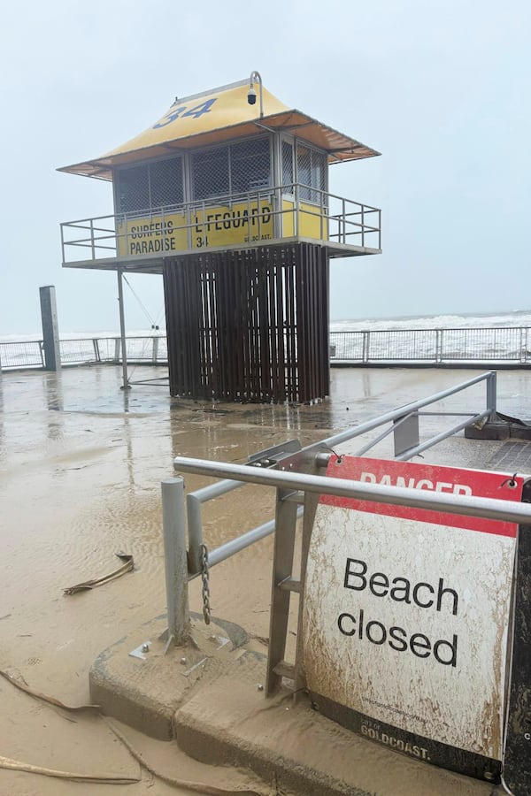 A sign saying "beach closed" following cyclone Alfred on the Gold Coast, Australia, Saturday, March 8, 2025. (AP Photo/John Pye)